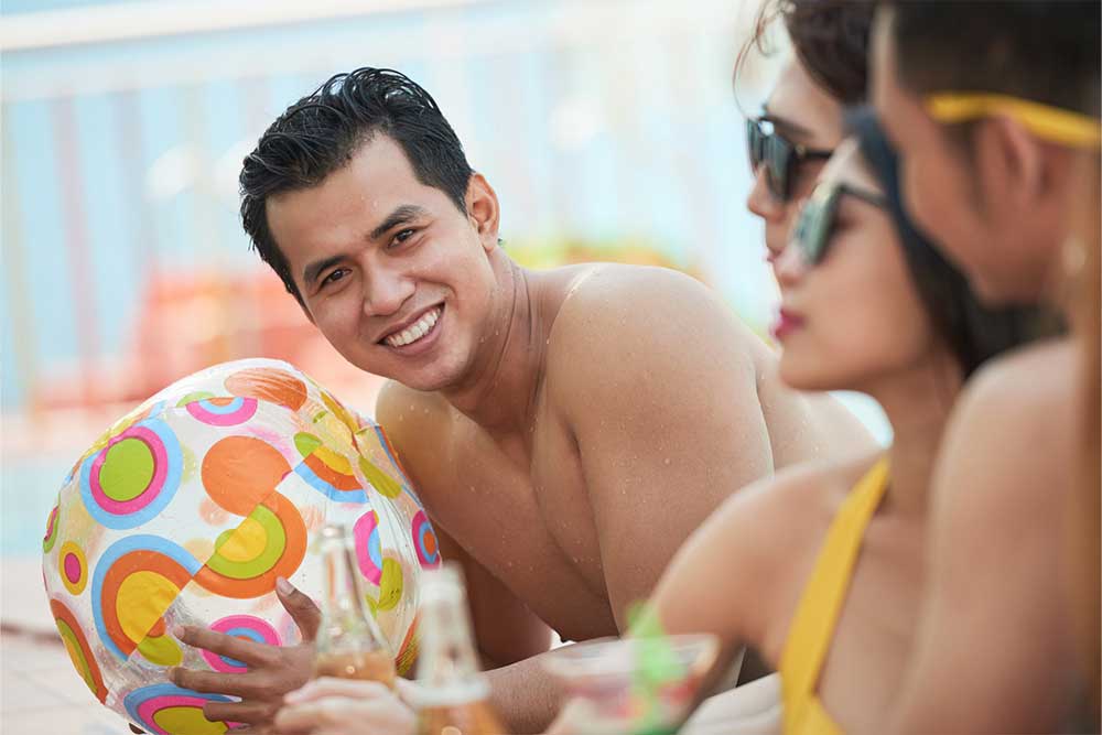 A guy holding a pool ball