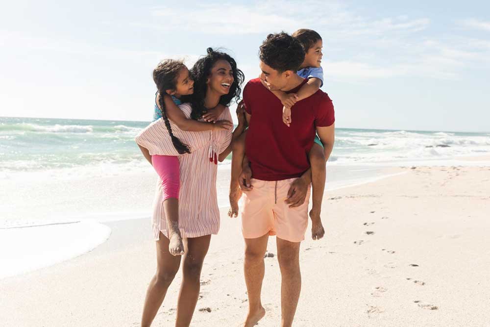 A family laughing on the beach