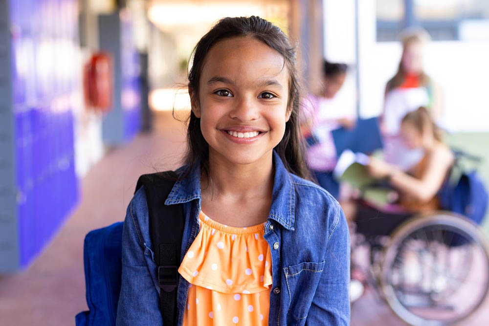 A young girl smiling at school